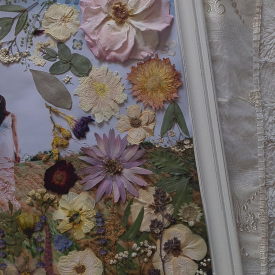 Video of Pressed flower art piece featuring delicate pink roses and green leaves.