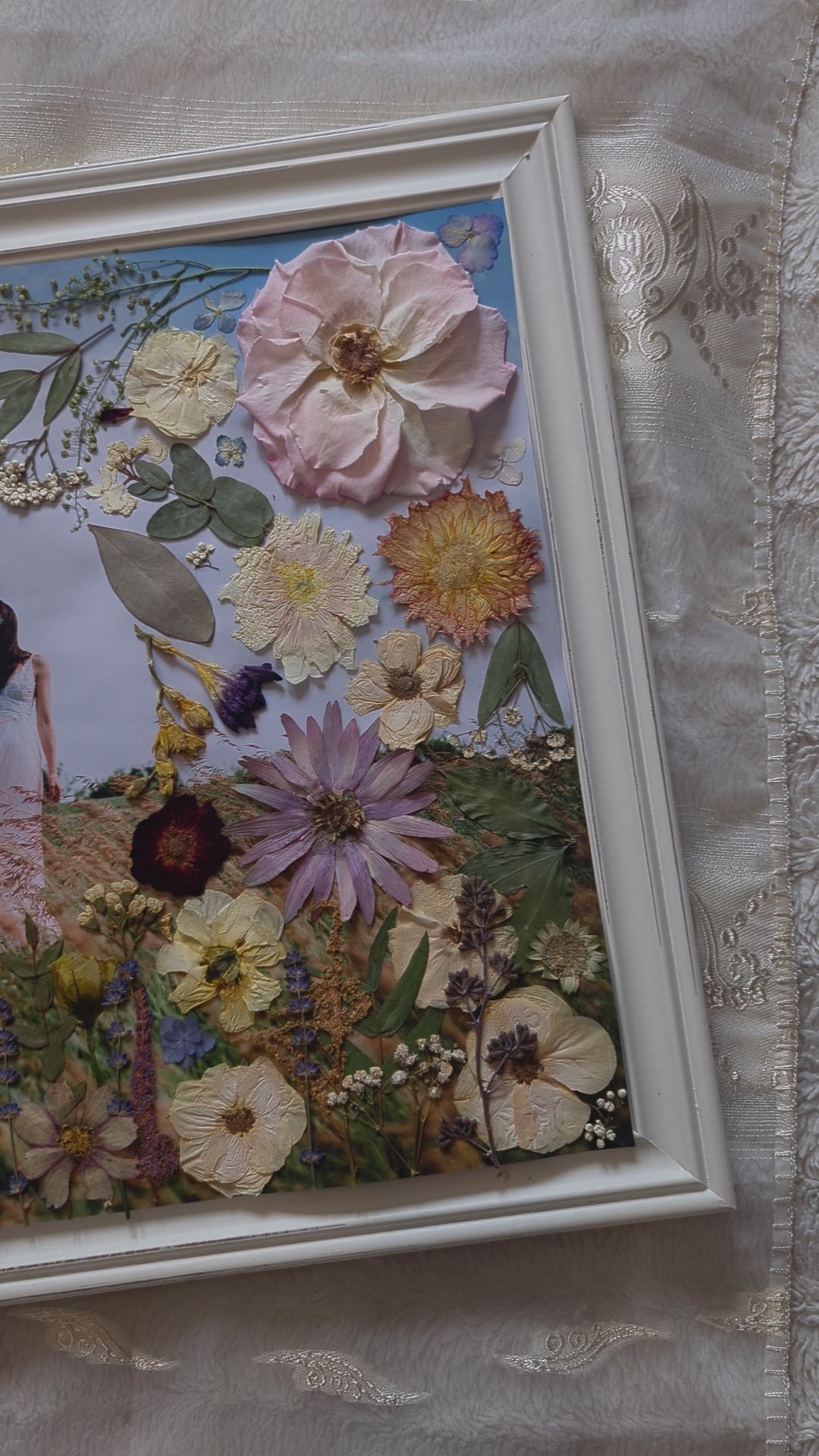 Video of Pressed flower art piece featuring delicate pink roses and green leaves.